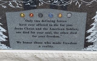 Large stone memorial installed on a government-run property at Monument Cemetary, CO bearing all military branch insignia with the inscription “Only two defining forces have ever offered to die for you, Jesus Christ and the American soldier. One died for your soul, the other died for your freedom. We honor those who made freedom a reality.”