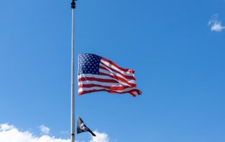 American flag flying at half staff