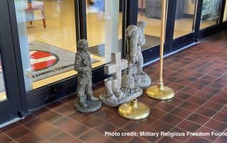Close up of Christian cross sculpture at entrance to Training Command building