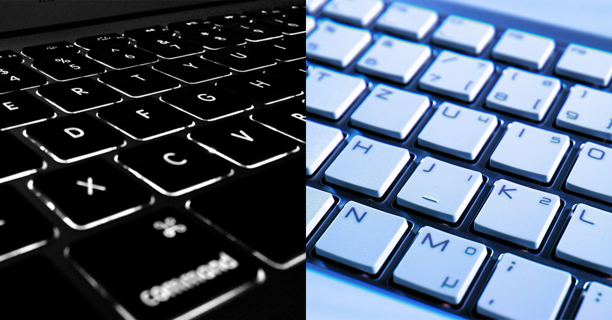 Split image of black computer keyboard and white computer keyboard