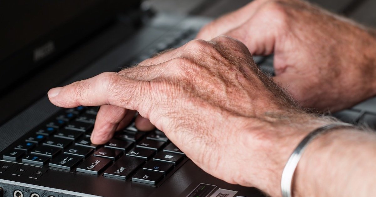 Hands typing on computer keyboard