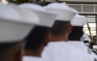 Sailors lined up shot from behind showing backs of their heads