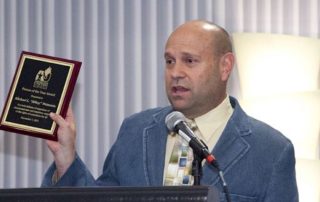 2011 photo of Mikey Weinstein receiving Americans United Person of the Year award