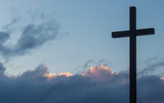 Cross with grey blue sky background