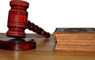 A judges gavel next to a bible