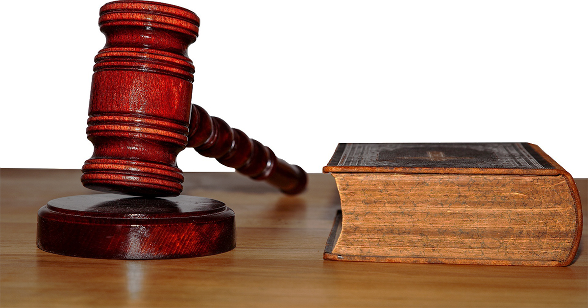 A judges gavel next to a bible