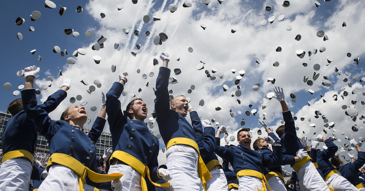 Graduating Air Force Academy cadets throw hats into the air