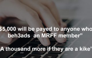 Hand on computer keyboard with text over image saying five thousand dollars will be payed to anyone who beheads an MRFF member and a thousand more if they are a kike