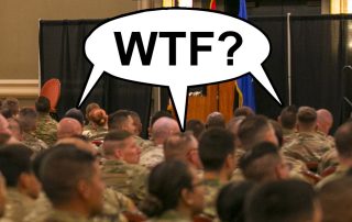 Audience of soldiers with balloon above their heads saying WTF