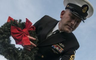 Military NCO holding Wreaths Across America wreath