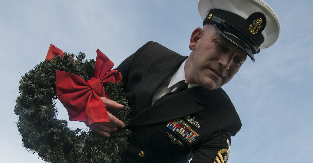 Military NCO holding Wreaths Across America wreath