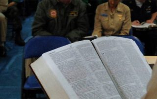 Open Bible in front of seated attendees