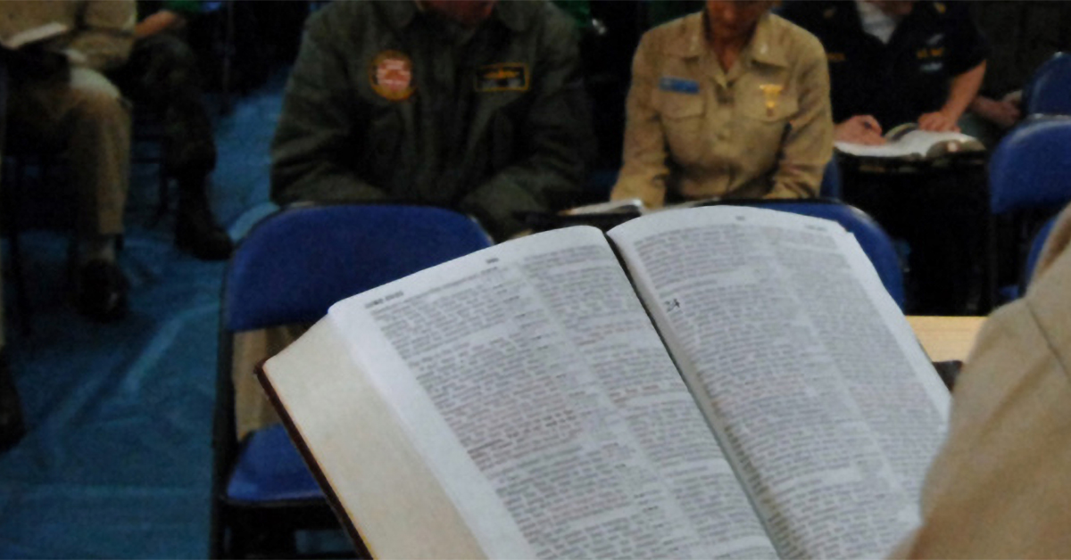 Open Bible in front of seated attendees
