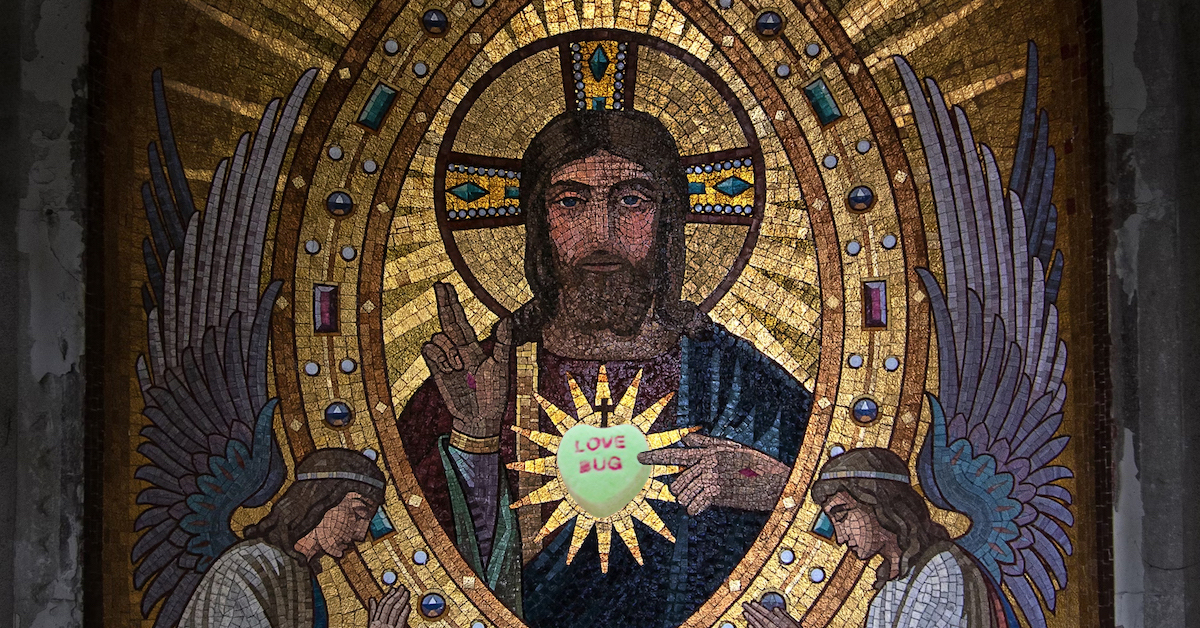 Medieval picture of grim looking sacred heart Jesus with a candy heart that says love bug superimposed over the sacred heart on his chest