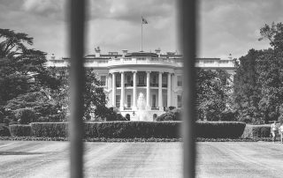 View of White House looking through bars of fence