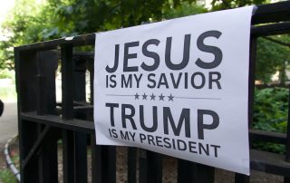 Sign on fence that says Jesus is my savior Trump is my president