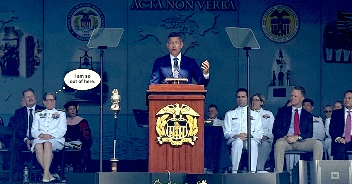Sean Duffy at podium delivering Marchant Marine Academy commencement address with Vice Admiral Nunan seated behind him with thought ballon above her head saying I am so out of here