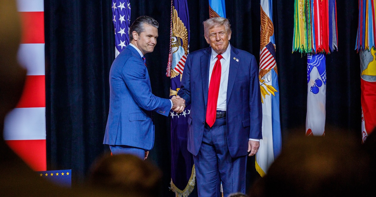 Hegseth shaking Trump's hand on stage at Quantico meeting