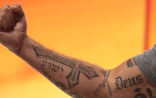 Pete Hegseth's arm covered in Christian and crusader tattoos