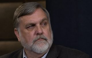 ai generated image of doug wilson looking off screen to the viewer's right